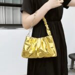 Siham sac à main d'épaule plissé doré - Accessoire de mode élégant pour femmes, porté avec style et sophistication."