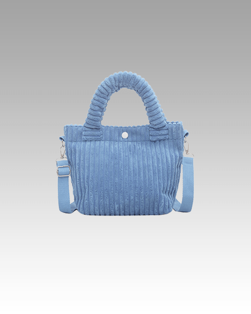 Découvrez le Daisy Sac à Main Fourre-Tout en Velours Côtelé Bleu, une fusion parfaite de style et de confort, offert exclusivement dans la boutique Izamel pour les femmes à la recherche de l'ultime accessoire.