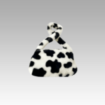 Sac à main motif vache Jamie en peluche, un accessoire tendance pour femmes disponible chez Izamel.