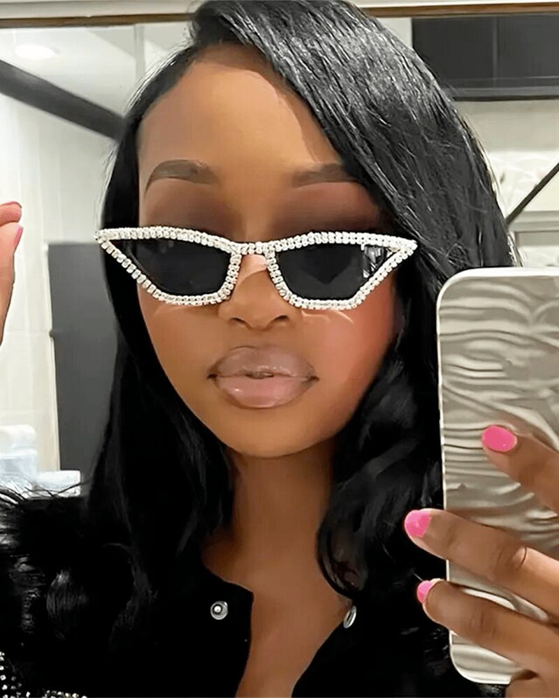 Femme portant les lunettes de soleil Naomie noires, ornées de strass, avec protection UV400.